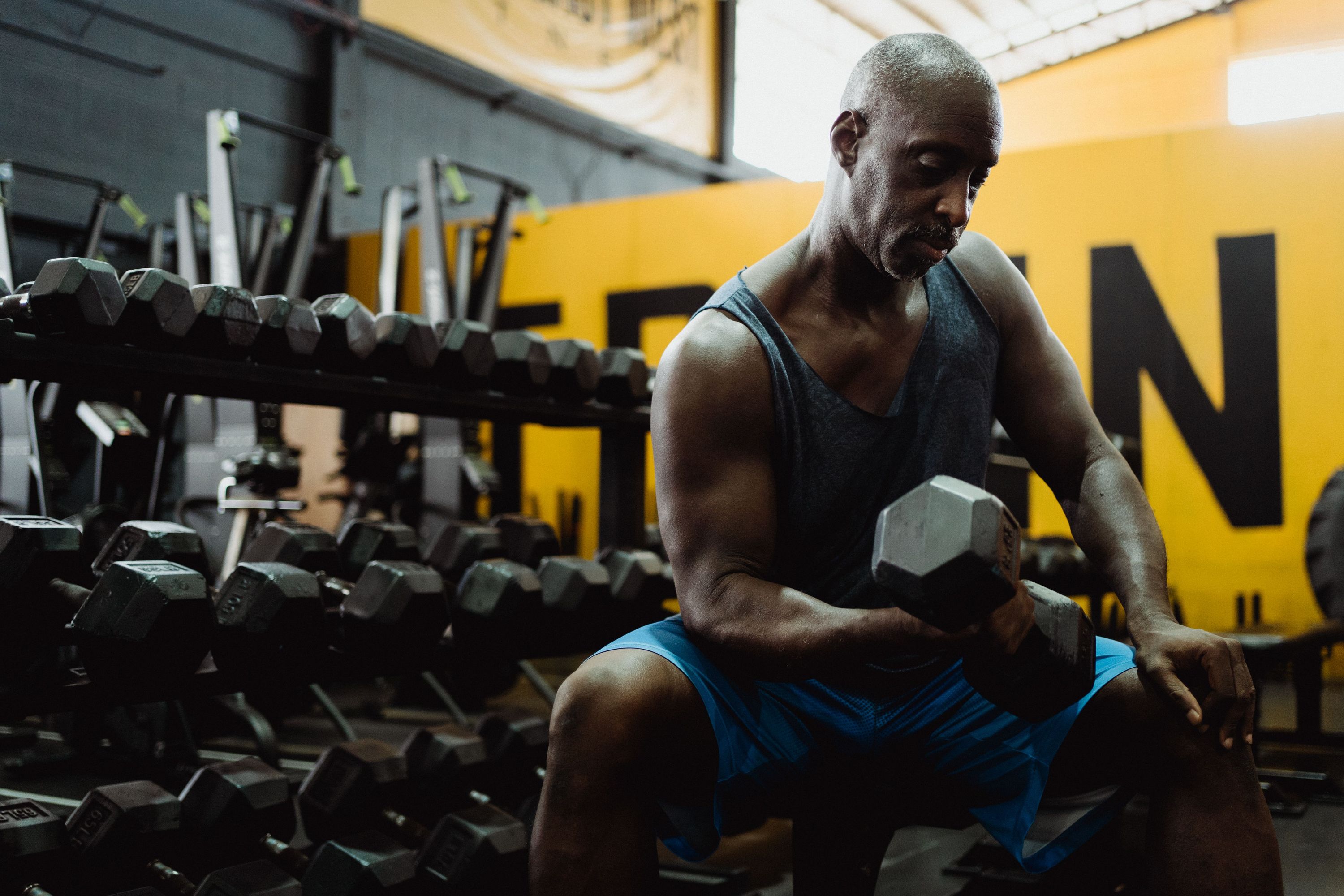 Man doing bicep curls in gym