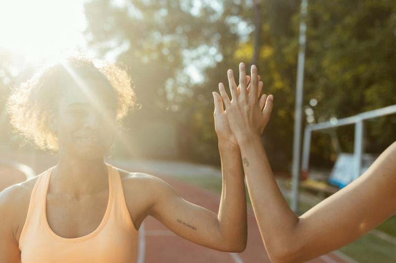 Runners high fiving after an outdoor workout