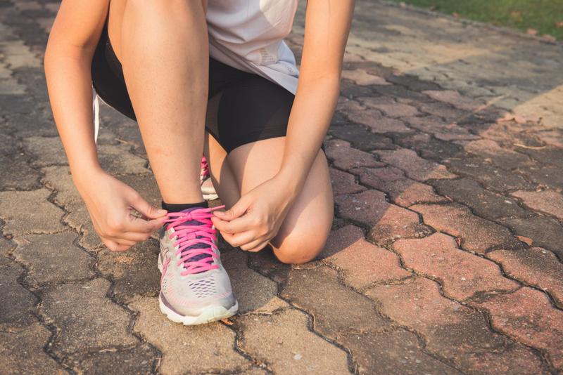Runner tying shoes