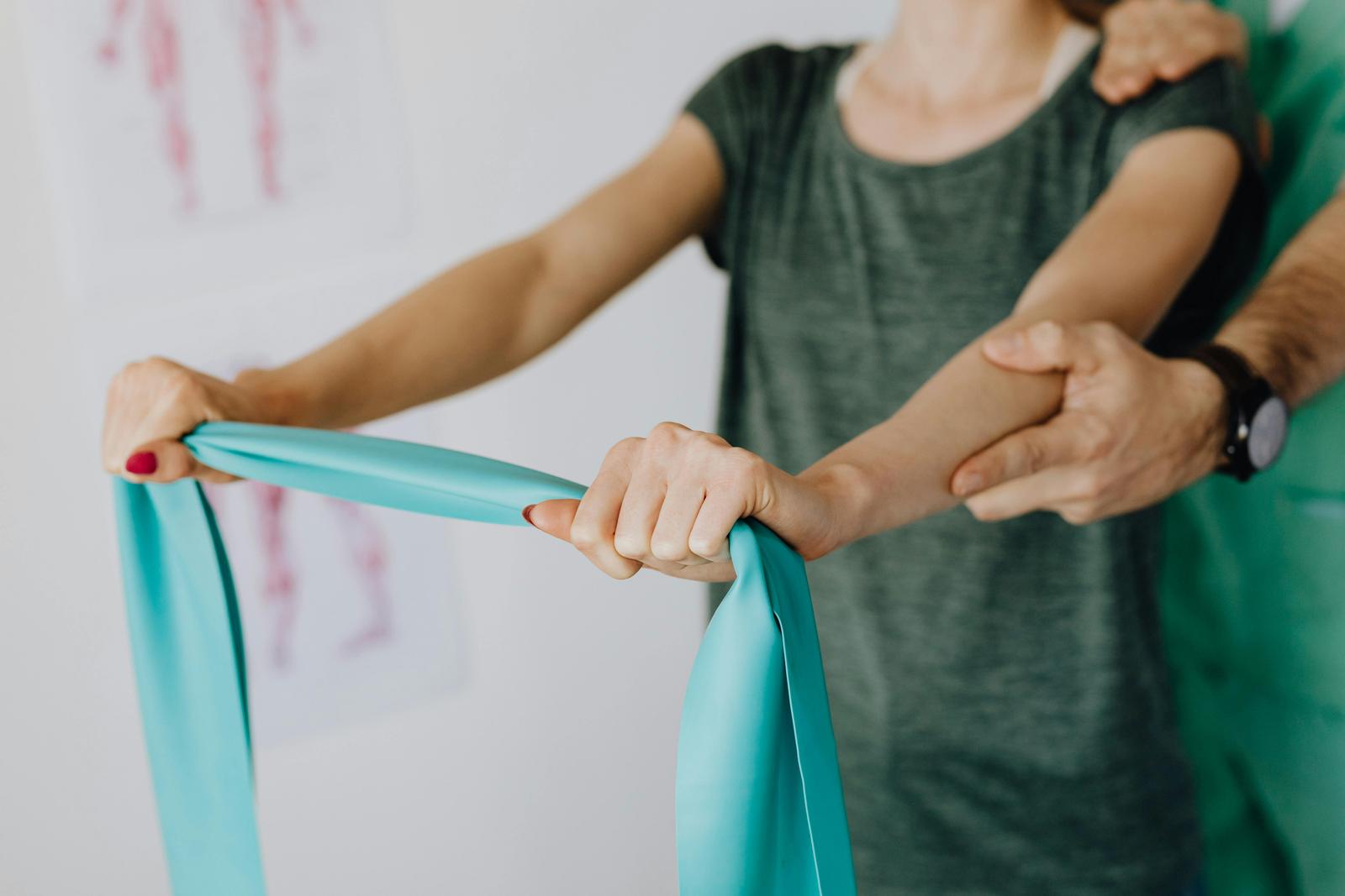 Someone doing shoulder rehab exercises with an exercise band