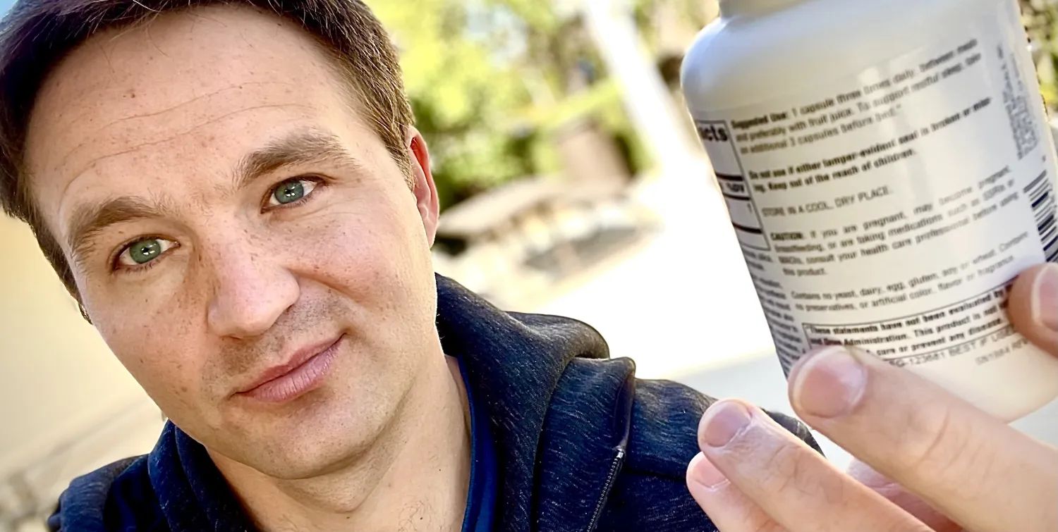 Trainer holding up a supplement bottle