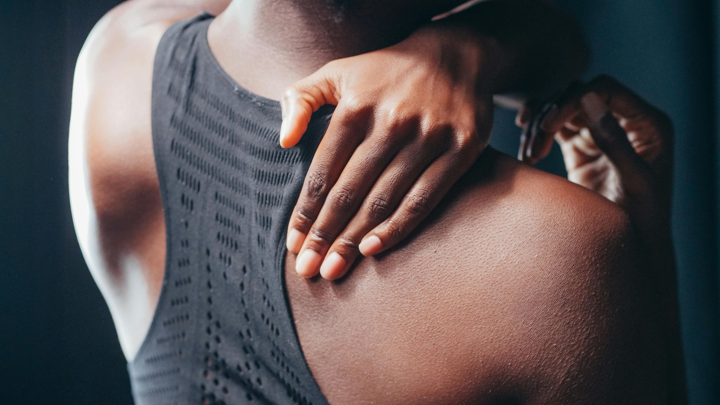 Athlete massaging a sore shoulder