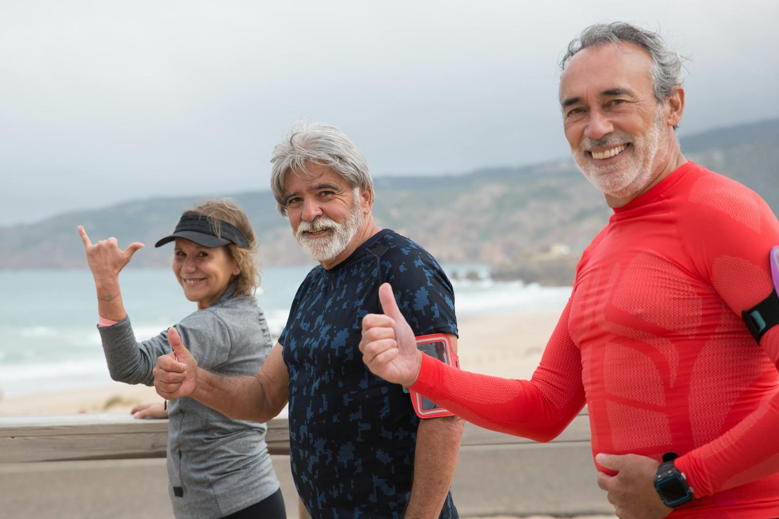Three outdoor fitness enthusiasts giving a thumbs up